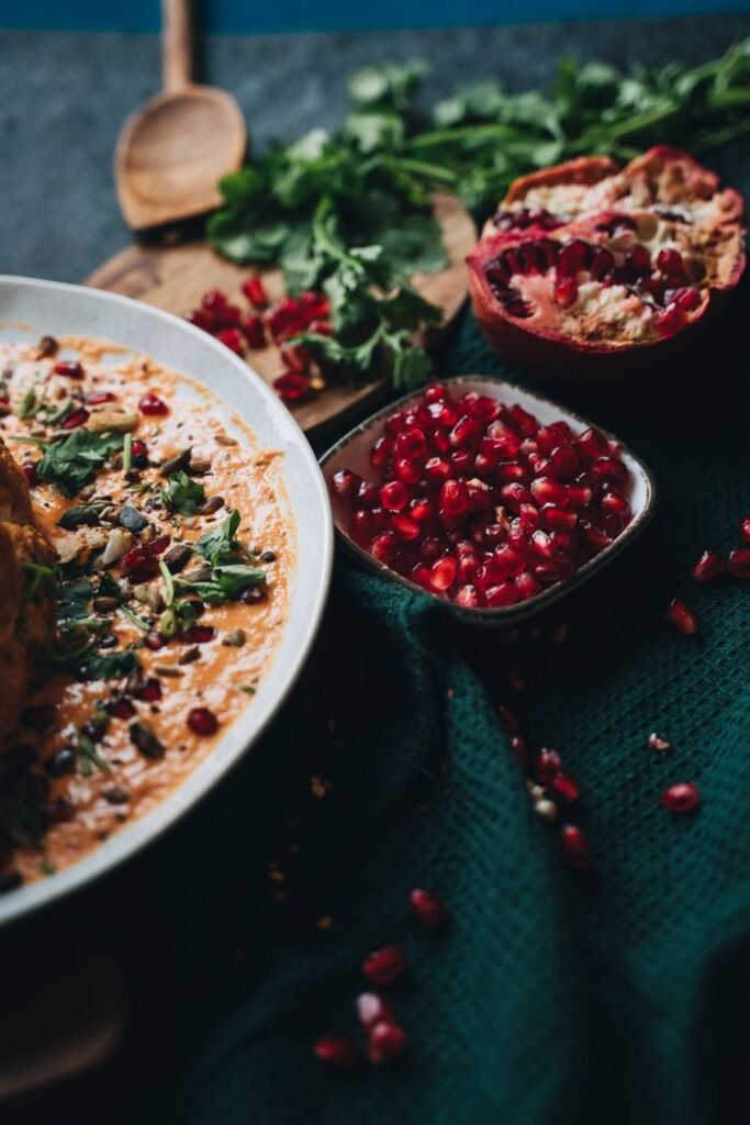 A deliciously styled vegan dish topped with vibrant pomegranate seeds, perfect for healthy meal inspiration.